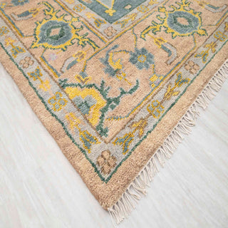 Modern hand-knotted rug with abstract geometric pattern in blush, teal, and mustard for large rooms.