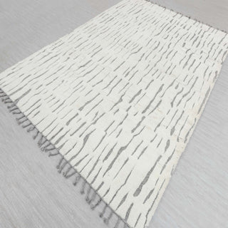 Modern hand-knotted rug with abstract linear pattern in ivory and grey, fringed edges