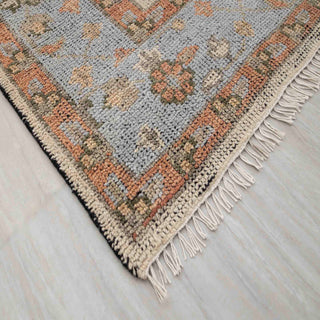 Modern hand-knotted rug with abstract tree-of-life linear pattern in ivory field and pastel blue border