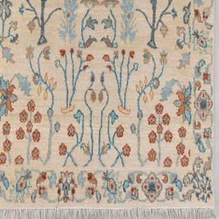 Modern hand-knotted rug with airy floral layout and slim tree pattern in ivory, pastel blue and warm rust.