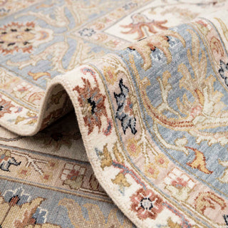 Modern hand-knotted rug with airy ivory background and pastel blue floral vines, durable wool 8x10 living room carpet.