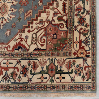 Modern hand-knotted rug with angular medallion pattern in slate blue, ivory, rust tones, perfect 12x15 area.