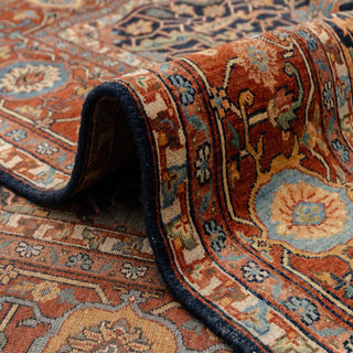 Modern hand-knotted rug with bold navy geometric layout framed by rich rust border, durable wool living room carpet.