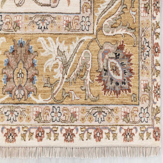 Modern hand-knotted rug with curvilinear floral pattern in ivory, beige, gold accents.