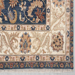 Modern hand-knotted rug with curvilinear floral pattern in navy, ivory, warm neutrals.