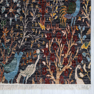 Modern hand-knotted rug with dense pictorial bird scene and organic branches in dark brown, blue and ochre.