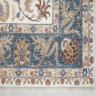 Modern hand-knotted rug with flowing botanical pattern on cream ground and ocean-blue border, muted gold accents, 9x12 ft