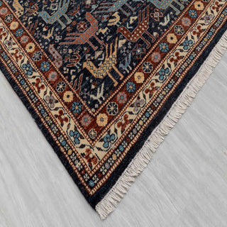 Modern hand-knotted rug with geometric bird pattern in navy, rust, cream accents, 4x6.