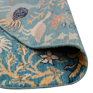 Modern hand-knotted rug with intricate organic Tree-of-Life pattern in teal blue and warm accents