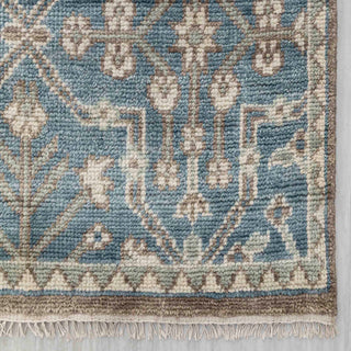 Modern hand-knotted rug with linear geometric trellis pattern in washed blue, beige and ivory accents.