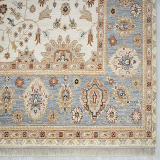Modern hand-knotted rug with open floral pattern and wide blue border in ivory, beige and powder-blue tones, 9x12