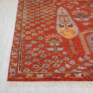 Modern hand-knotted rug with pictorial garden layout, architectural arches and trees in rust, blue and soft gold.