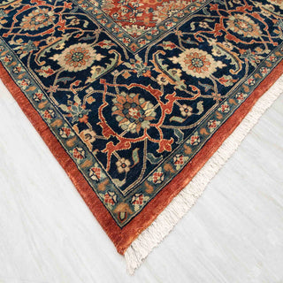 Modern hand-knotted rug with richly detailed rust ground and dark navy floral border, durable wool 10x14 carpet
