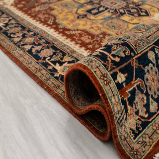 Modern hand-knotted rug with striking geometric medallion layout in rust field, gold center, and navy border, durable wool 6x9 carpet