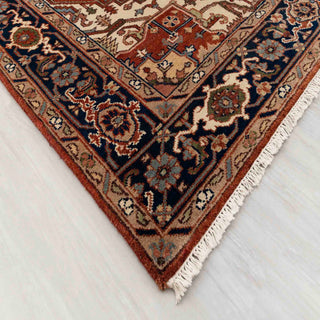 Modern hand-knotted rug with striking geometric medallion layout on rust field and navy border, durable wool 6x9 carpet