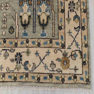 Modern hand-knotted rug with vertical tree-of-life pattern in sage, cream, navy accents, 8x10