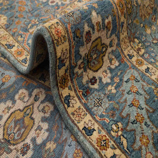 Modern hand-knotted wool rug with intricate floral lattice pattern in teal, gold and rust tones, 8x10 size