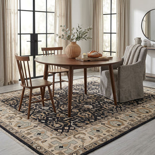 Modern hand-knotted rug with graphic geometric pattern and strong border contrast in black, cream and taupe.