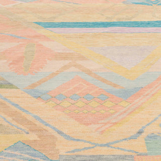 Moroccan-style hand-knotted rug with abstract tribal motifs in pastel peach, aqua, yellow on a light ground.