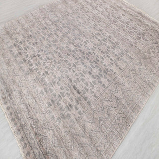 Moroccan-style hand-knotted rug with tonal tribal motif in warm grey and sand neutrals.