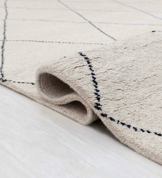 Moroccan Beni Ourain-style hand-knotted rug with geometric lattice motif in cream and black.