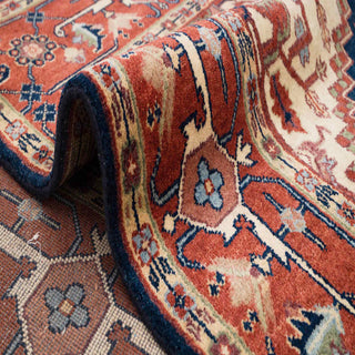 Northwest Persian Heriz hand-knotted rug with tribal medallion motif in navy, terracotta, ivory tones.