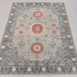 Oriental hand-knotted rug in grey, blue, rust with geometric medallion design, 9x12 size.