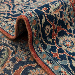 Oriental hand-knotted wool rug in rust and navy with ivory floral highlights, 8x10 size perfect for dining or lounge