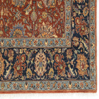 Oriental hand-knotted wool rug in rust with navy vine-and-flower border and teal highlights, classic 6x9 for large rooms