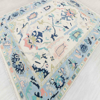 Oushak-style hand-knotted rug in ivory, blue, green, coral with abstract floral design, 8x10.