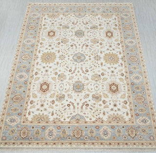 Oushak-style hand-knotted rug in ivory, sky blue, beige with large floral vine pattern design, 9x12 ft