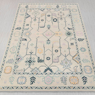 Oushak-style hand-knotted rug in ivory, teal, pastel yellow with playful floral design, 10x14