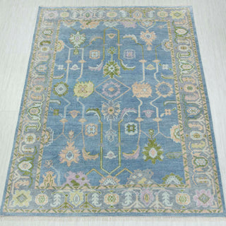 Oushak-style hand-knotted rug in pastel blue with soft floral geometric design, 8x10 size