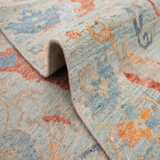 Oushak-style hand-knotted rug with central palmette motif in celadon red teal.