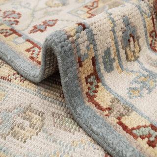 Oushak-style hand-knotted rug with geometric floral medallion motif in blue, ivory, rust, taupe tones