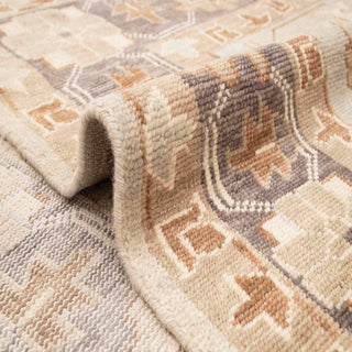 Oushak-style hand-knotted rug with tribal medallion and floral motifs in brown, beige, gray tones.