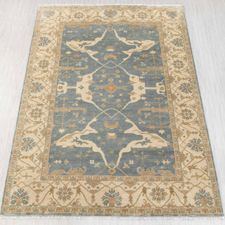 Oushak hand-knotted rug in blue and gold with floral medallion design, 9x12 living room size.