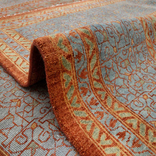 Persian-inspired hand-knotted rug with fine lattice and garden motifs in terracotta, olive, slate blue tones.