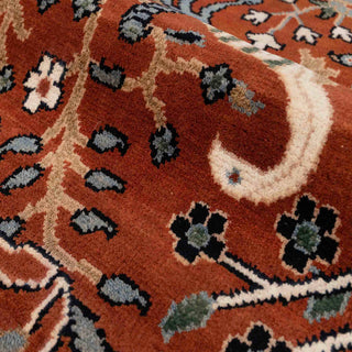 Persian-style hand-knotted rug with Tree of Life and bird motif in terracotta red, blue, ivory.