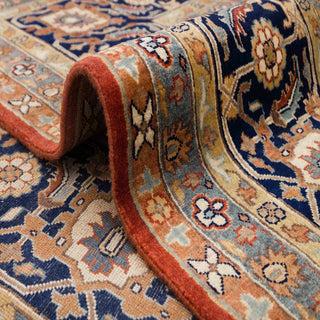 Persian-style hand-knotted rug with botanical motifs and palmettes in rust, blue, and ivory, grand 10x14 area.