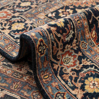 Persian-style hand-knotted rug with botanical motifs in navy, camel, and burgundy, versatile 6x9 living room area.