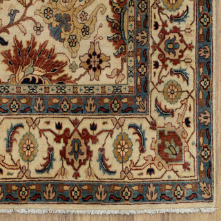 Persian-style hand-knotted rug with ornate floral motifs in cream, brown, blue, and gold, room-size 6x9 