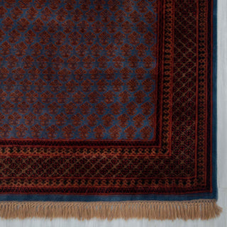 Persian-style hand-knotted rug with repeating boteh motif in blue, burgundy, rust tones, 6x9.