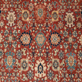 Persian-style hand-knotted rug with rich rust ground, blue accents, and intricate floral pattern, classic 8x10 carpet