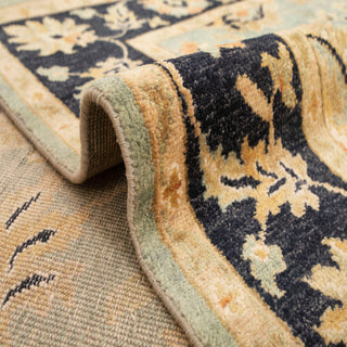 Persian-style hand-knotted rug with scrolling floral motifs in sage, gold, navy tones, 5x8