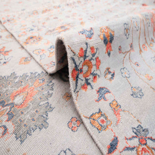 Persian-style hand-knotted rug with symmetrical floral motif in ivory, rust, and grey tones