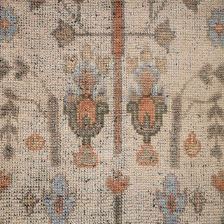 Persian-style hand-knotted rug with traditional tree-of-life motif in soft ivory, blue, and earth tones