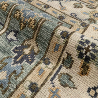 Persian-style hand-knotted rug with tree-of-life and flower motifs in teal and beige tones, 8x10