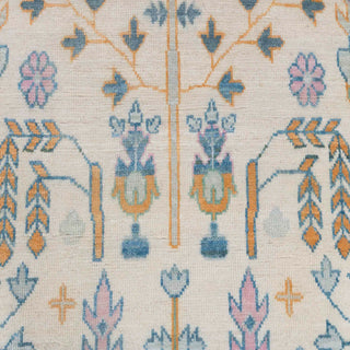 Persian-style hand-knotted rug with tree-of-life motif in light blue and cream tones, 8x10