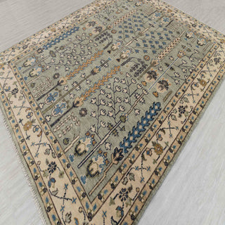 Persian-style hand-knotted rug with tree-of-life prayer motif in soft green and beige tones, 8x10
